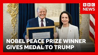 The Venezuelan winner of the Nobel Peace Prize hands her medal to Donald Trump.